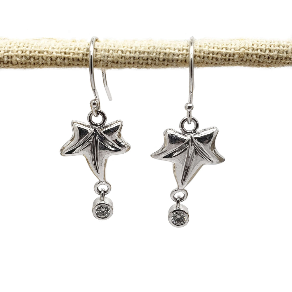 Pair of 14kt white gold leaf-shaped dangle earrings with bezel set diamonds