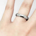 14kt white gold low dome wedding ring worn on a hand