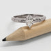 14kt white gold marquise lab diamond ring with engraved band beside a pencil