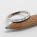 14kt white gold millgrain wedding ring resting on a wooden pencil