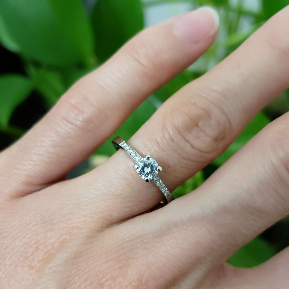 14kt white gold moissanite and lab diamond ring shown on hand