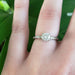 14kt white gold moissanite engagement ring shown on hand