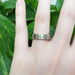 14kt white gold mountain range wedding ring worn on hand, brushed finish