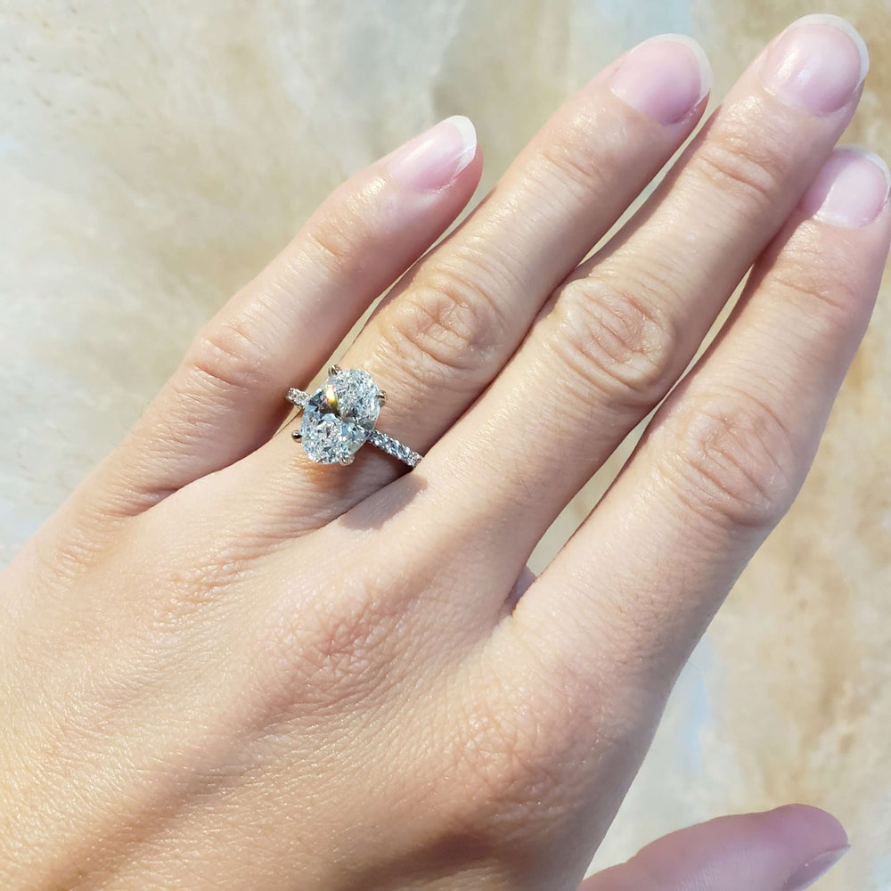14kt white gold oval lab diamond engagement ring with pave band shown on hand