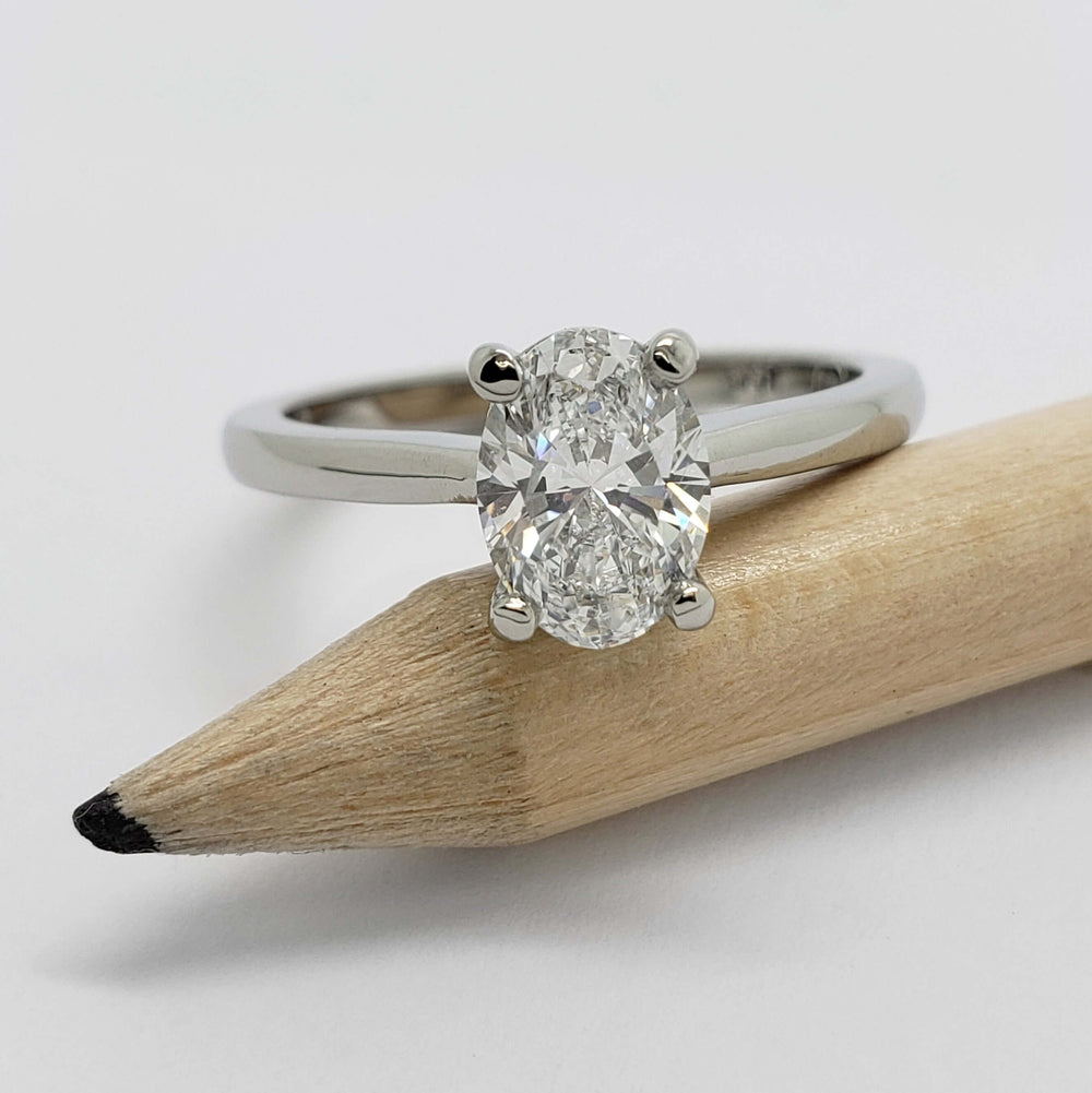 14kt white gold oval lab diamond ring displayed on a pencil