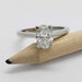 14kt white gold oval lab diamond ring displayed on a pencil