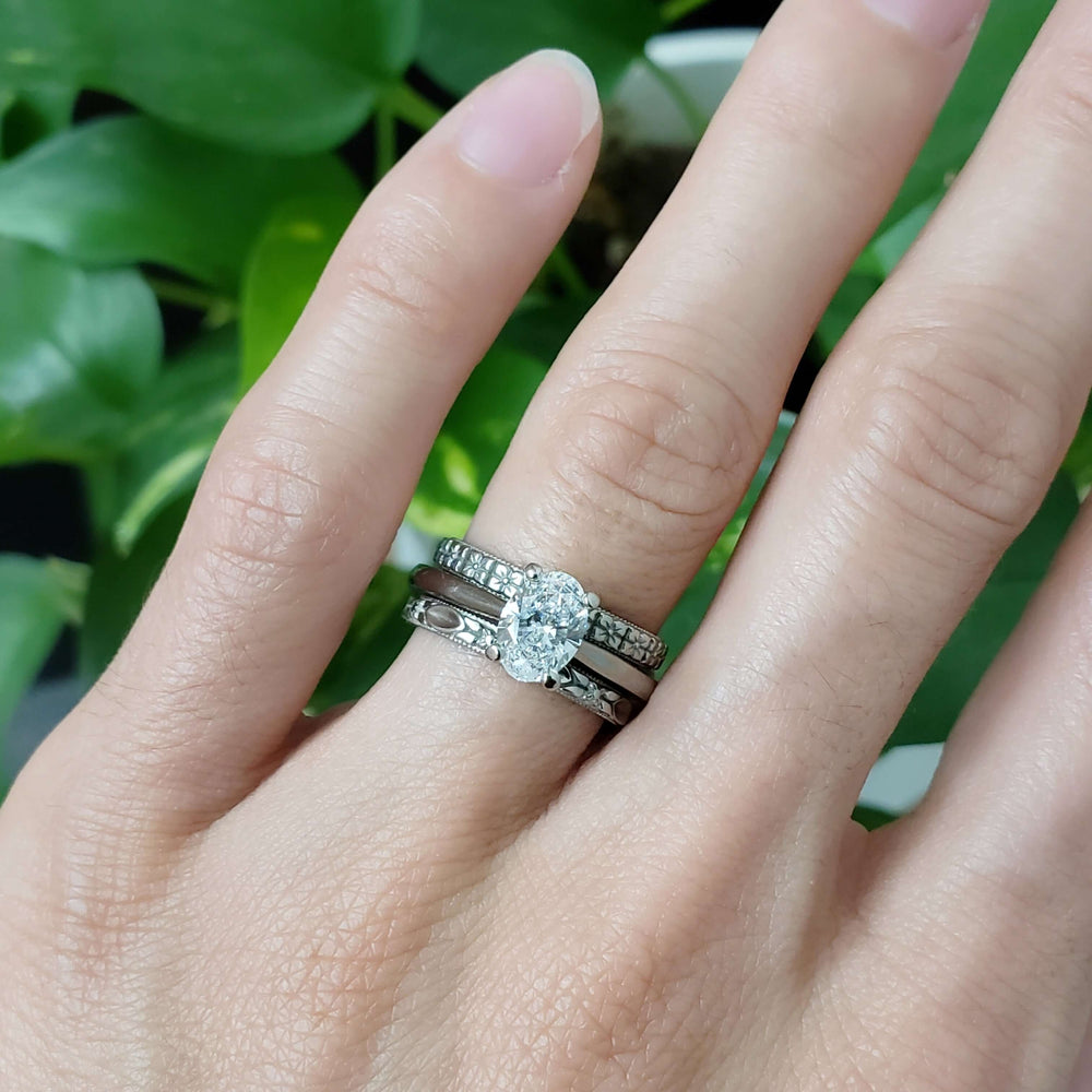 14kt white gold oval lab diamond ring stacked with diamond bands on hand