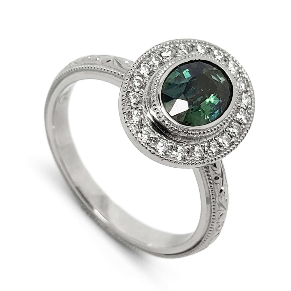14kt white gold ring with oval teal Australian sapphire and diamond halo, engraved band