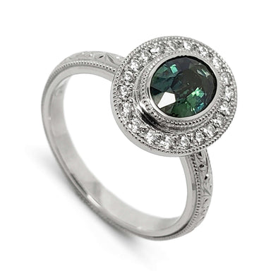 14kt white gold ring with oval teal Australian sapphire and diamond halo, engraved band