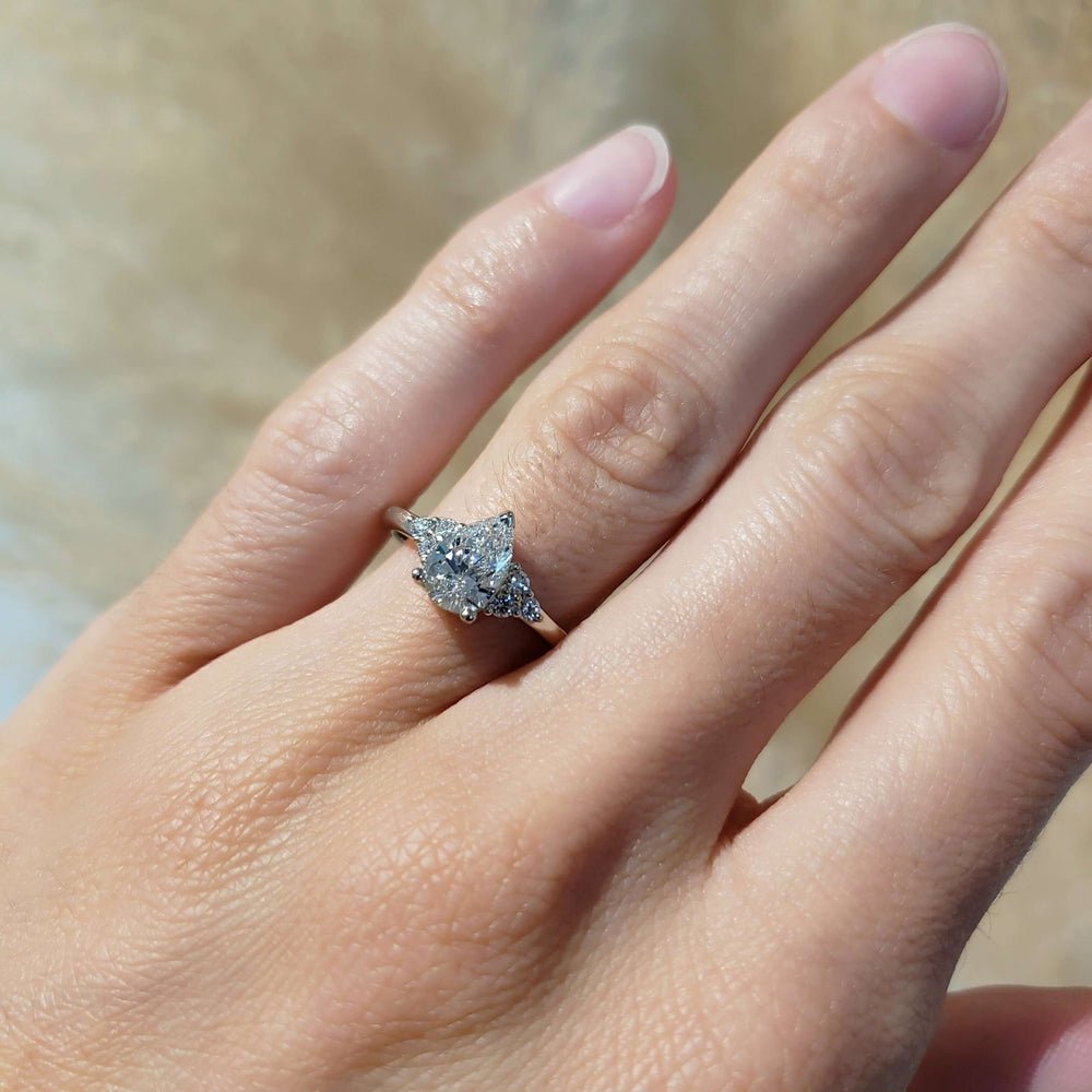 14kt white gold pear lab diamond engagement ring shown on hand