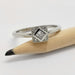 14kt white gold engagement ring with princess cut lab diamond shown next to a pencil
