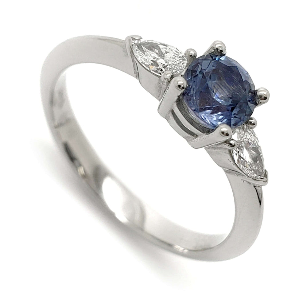 14kt white gold ring with round blue Montana sapphire and two pear cut lab grown diamonds