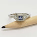Artisan 14kt white gold ring with square lavender sapphire and two lab diamonds, shown with pencil for scale