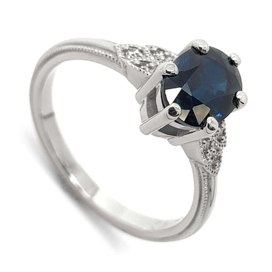 14kt white gold ring with oval blue Australian sapphire and Canadian diamond accents, millgrain detail