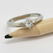 14kt white gold rose cut diamond ring resting on a pencil