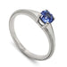 14kt white gold solitaire engagement ring with round blue sapphire and millgrain detail