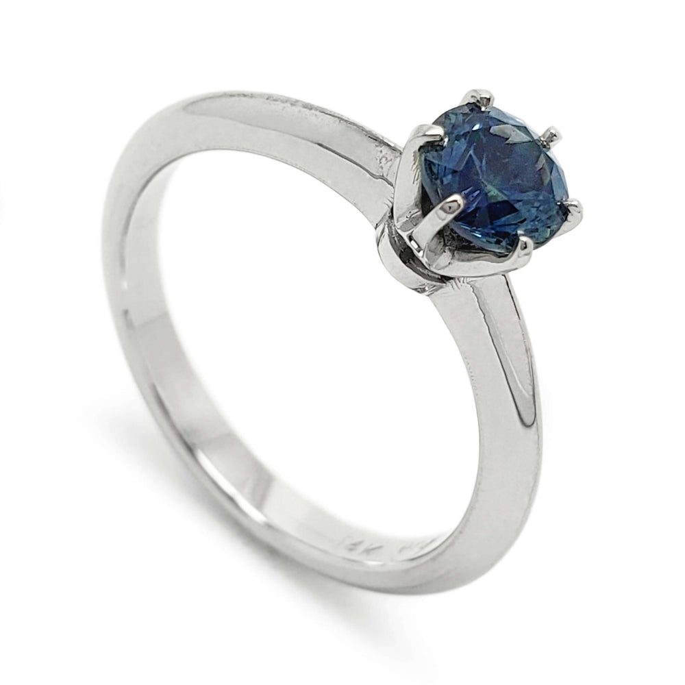 14kt white gold solitaire ring with round blue Montana sapphire in six-claw setting