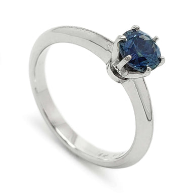 14kt white gold solitaire ring with round blue Montana sapphire in six-claw setting