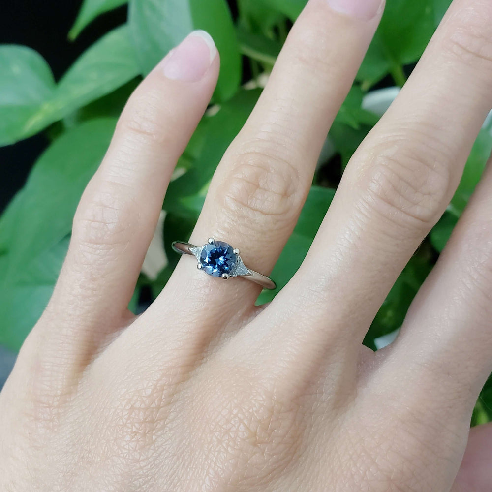 14kt white gold spinel and diamond engagement ring worn on a hand