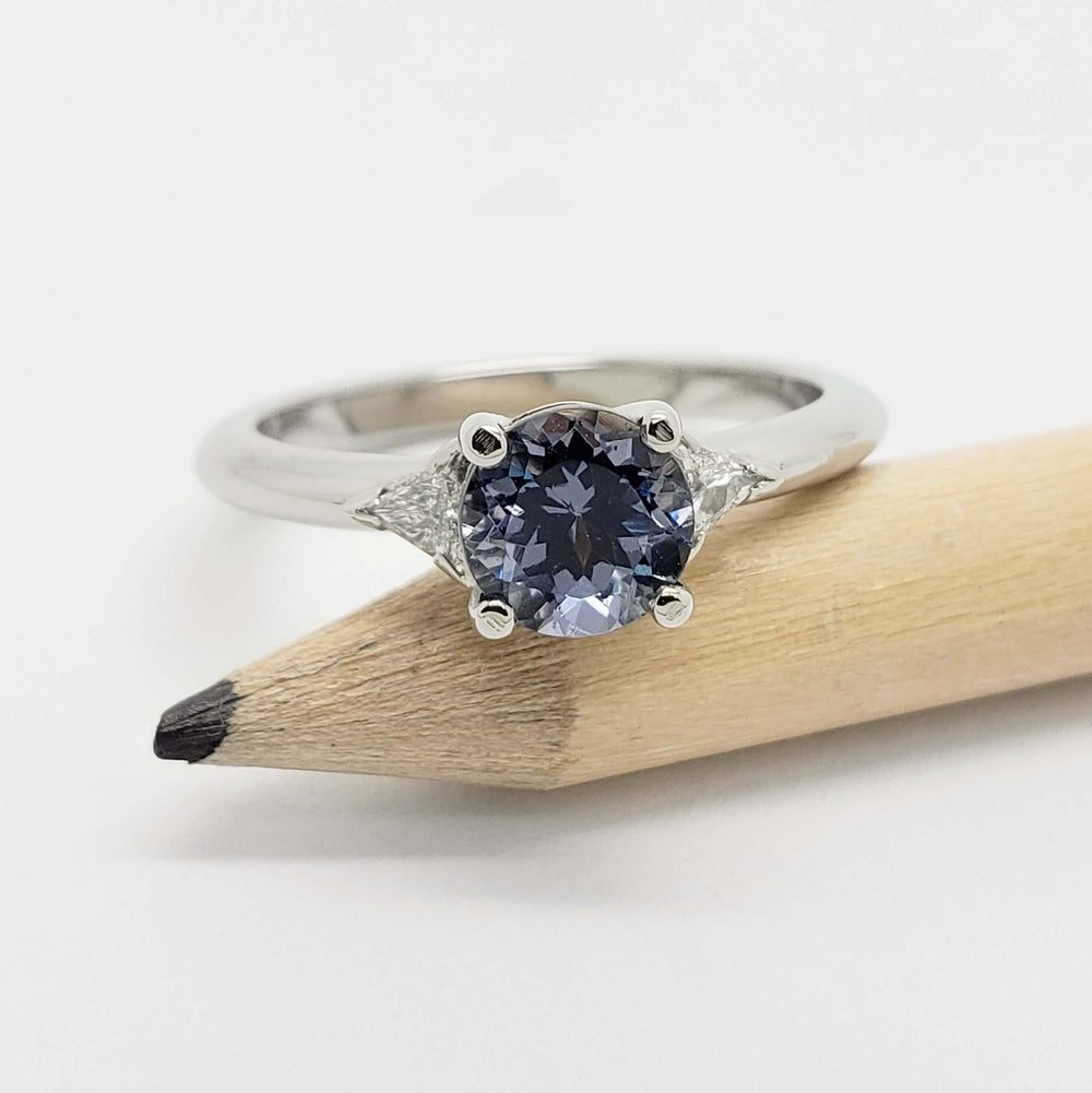 14kt white gold spinel and diamond ring displayed on a pencil