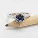 14kt white gold spinel and diamond ring displayed on a pencil