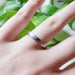 14kt white gold textured wedding band shown on a hand