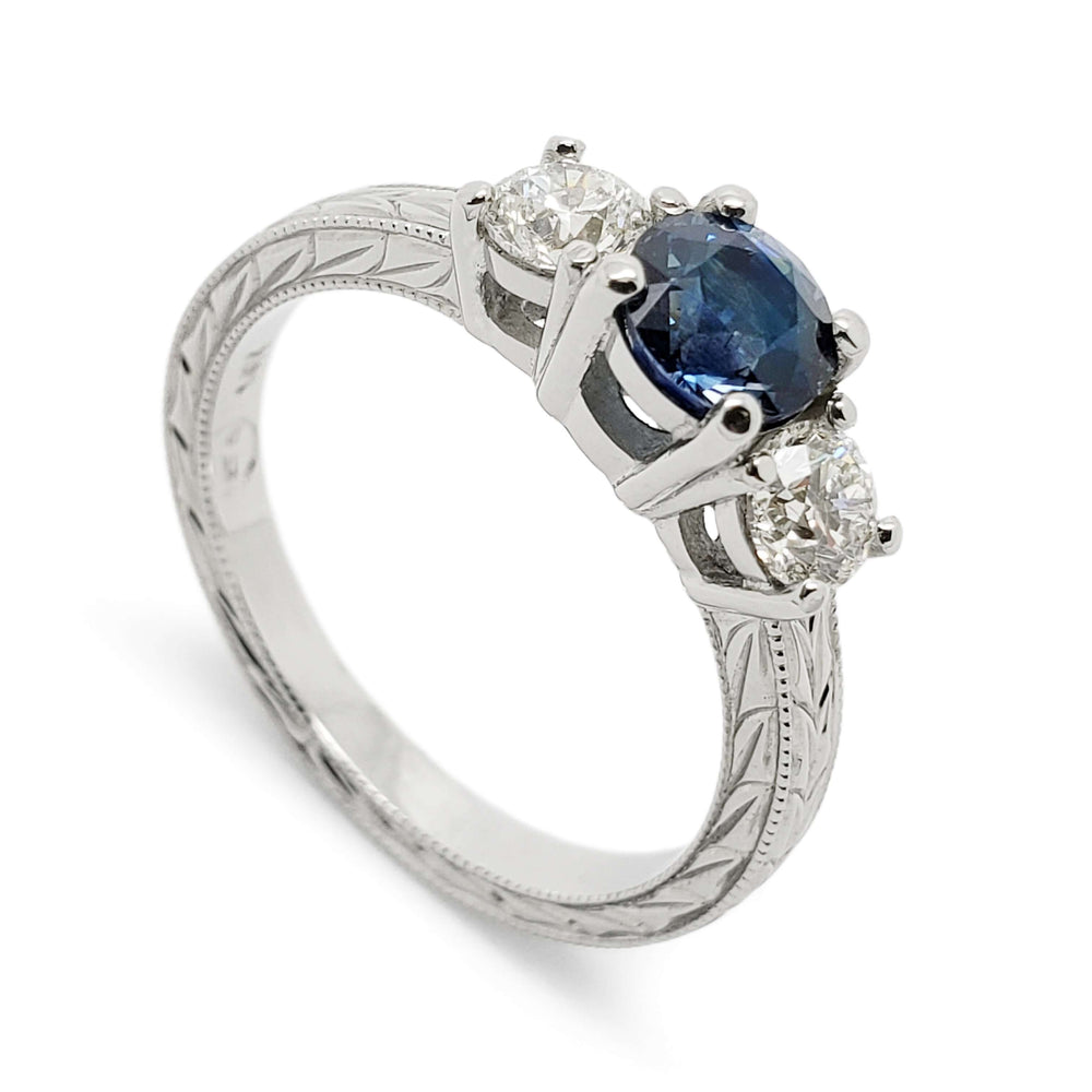 14kt white gold three-stone ring with teal Montana sapphire and Canadian diamonds, engraved band