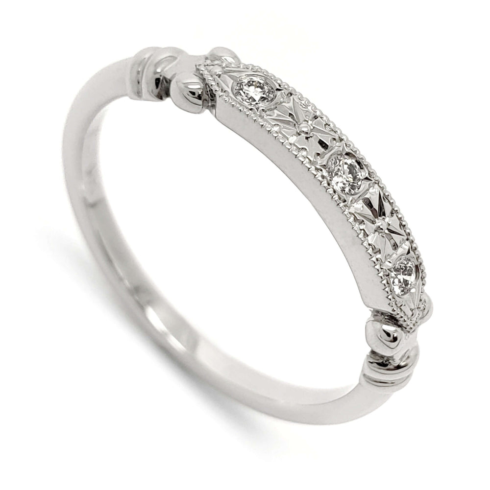 14kt white gold wedding ring with three Canadian diamonds, floral engraving, and millgrain detail