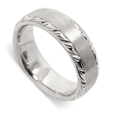 14kt white gold wedding ring with brushed top and engraved edges, angled view