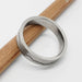 14kt white gold wedding ring with mountain range engraving, interior hallmark visible, on pencil