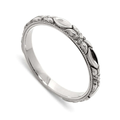 14kt white gold wedding ring with raised leaf and flower details, millgrain edge