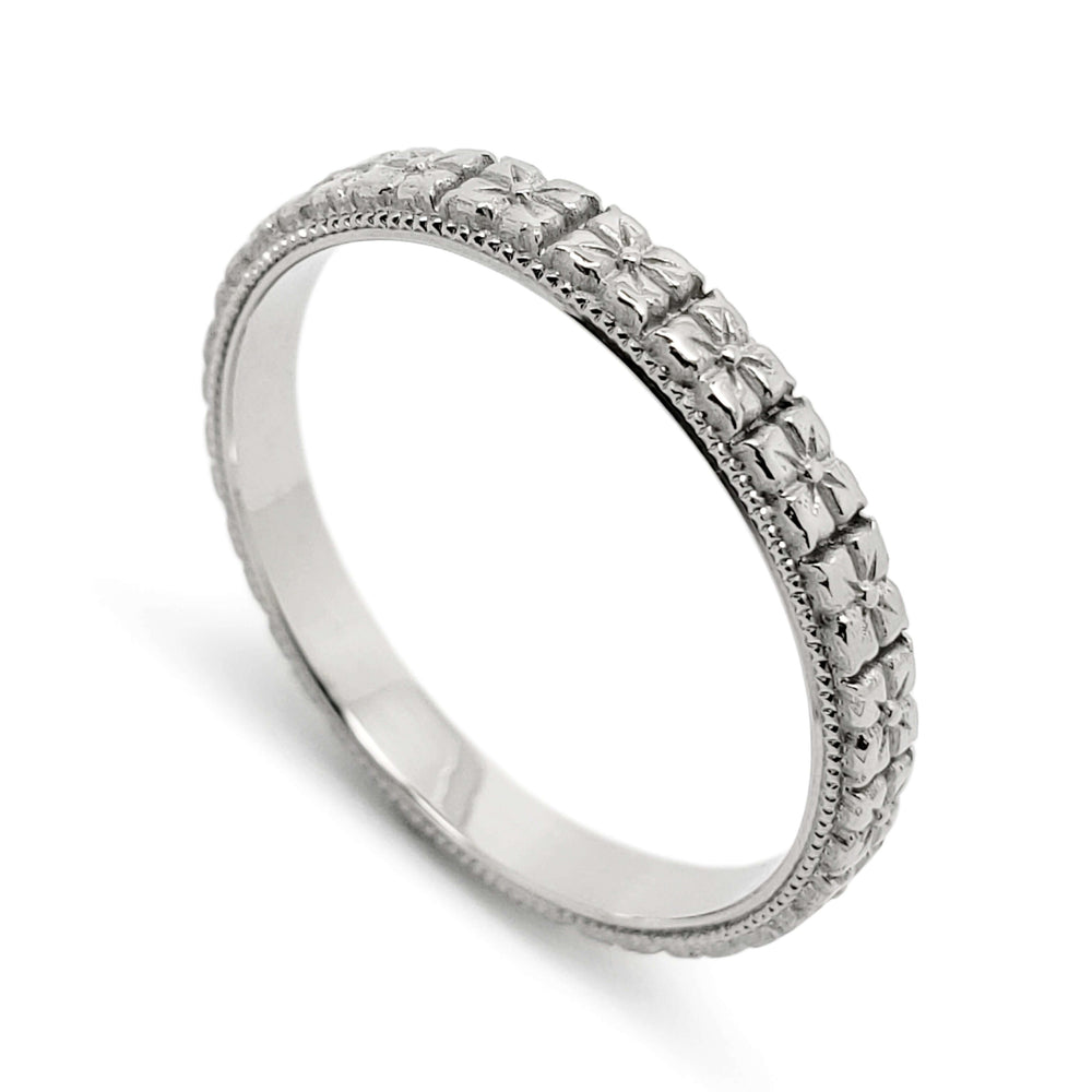 14kt white gold wedding ring with sculpted floral pattern and millgrain edge
