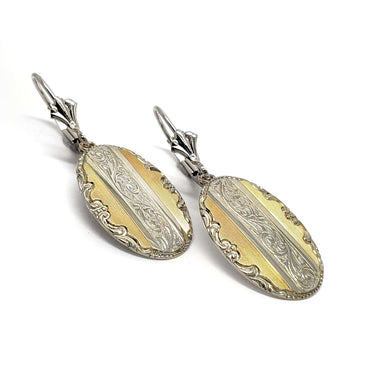 Pair of oval drop earrings in 14kt yellow and white gold with ornate engraved pattern