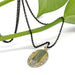 Engraved 14kt yellow and white gold pendant displayed on a black chain with a green plant