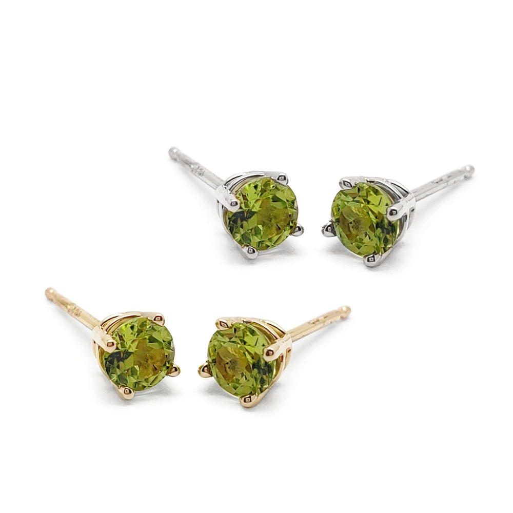 Pair of 14kt yellow and white gold peridot stud earrings in a 4-claw setting