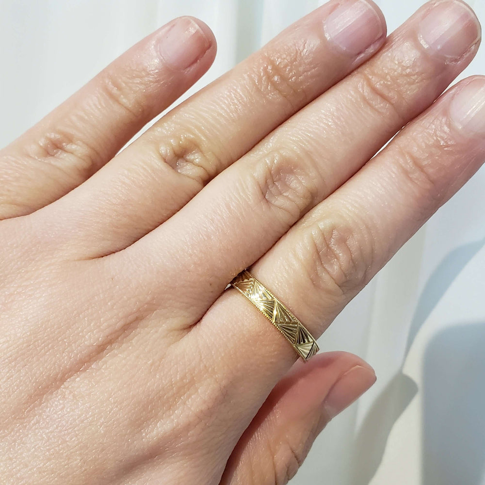 14kt yellow gold Art Deco engraved wedding ring shown on a hand