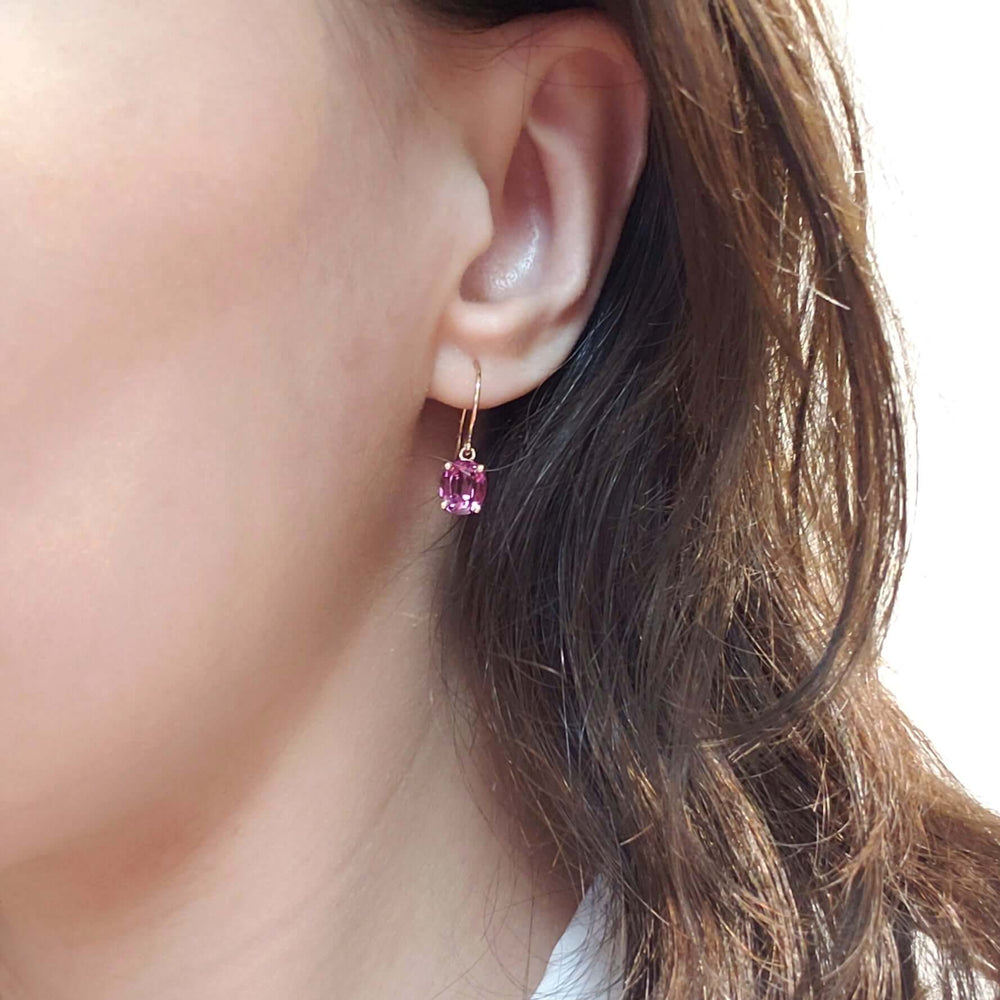 14kt yellow gold drop earring with oval Madagascar garnet shown worn on ear