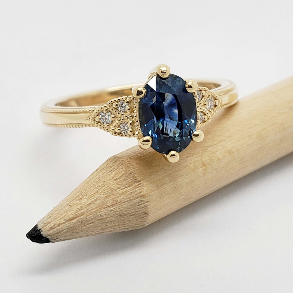 14kt yellow gold Montana sapphire engagement ring shown with a pencil for scale
