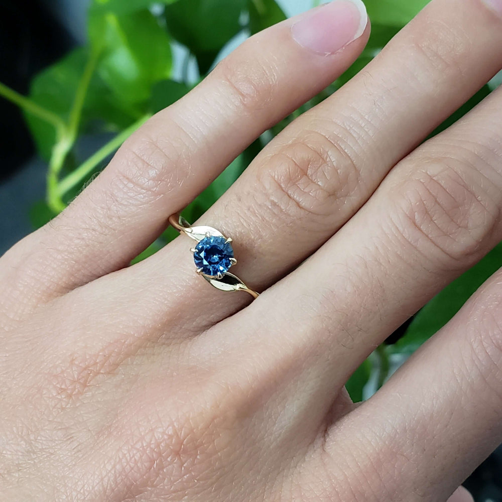 14kt yellow gold Montana sapphire engagement ring worn on hand