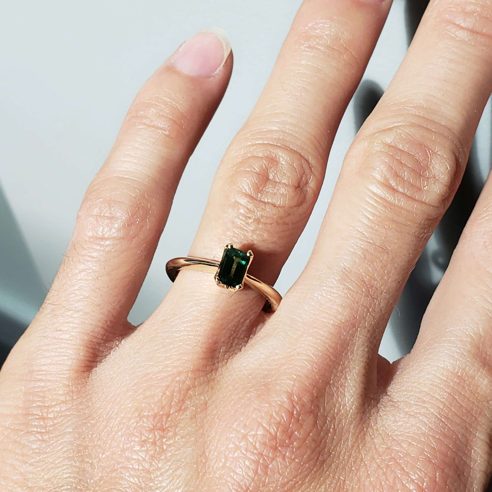 14kt yellow gold Tanzanian sapphire ring worn on hand, natural light