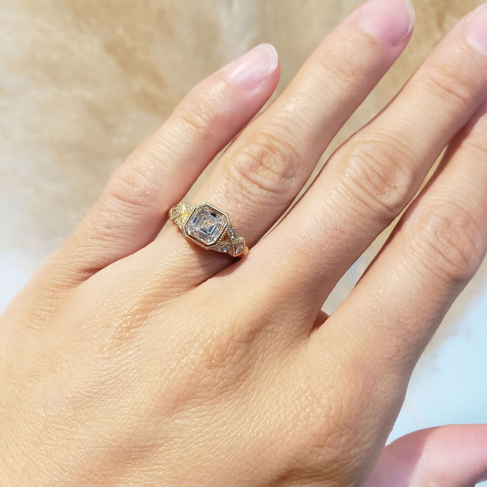 14kt yellow gold asscher cut lab diamond engagement ring shown on a hand