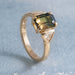 14kt yellow gold bi-coloured sapphire and trillion diamond ring on blue background