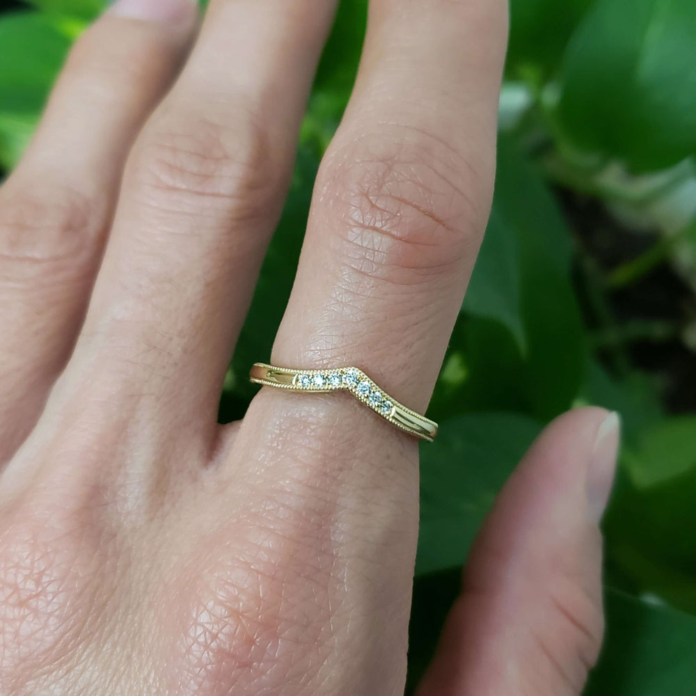 14kt yellow gold chevron diamond wedding ring worn on hand