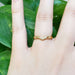 14kt yellow gold chevron diamond wedding ring worn on a hand