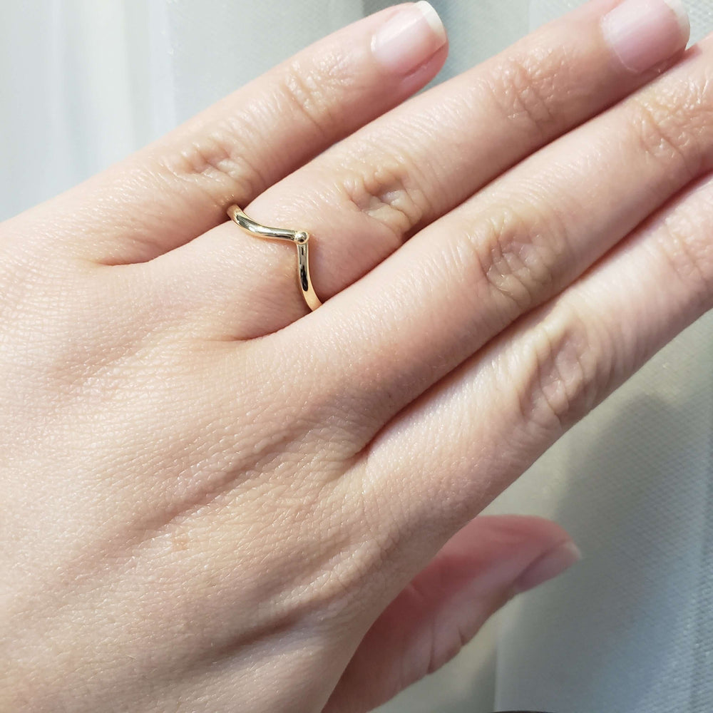14kt yellow gold chevron wedding ring shown on hand