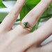14kt yellow gold chevron wedding ring stacked with a teal gemstone engagement ring