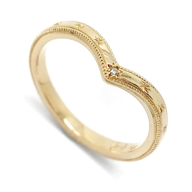 14kt yellow gold chevron wedding ring with engraved stars and a star-set diamond