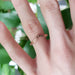 14kt yellow gold chevron wedding ring with wheat engraving, worn on a finger