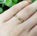 14kt yellow gold diamond engagement ring with leaf details shown on a hand
