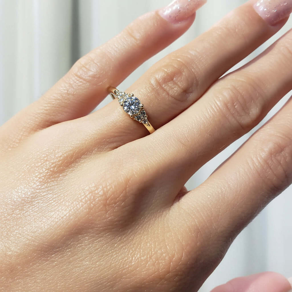 14kt yellow gold diamond engagement ring worn on a hand